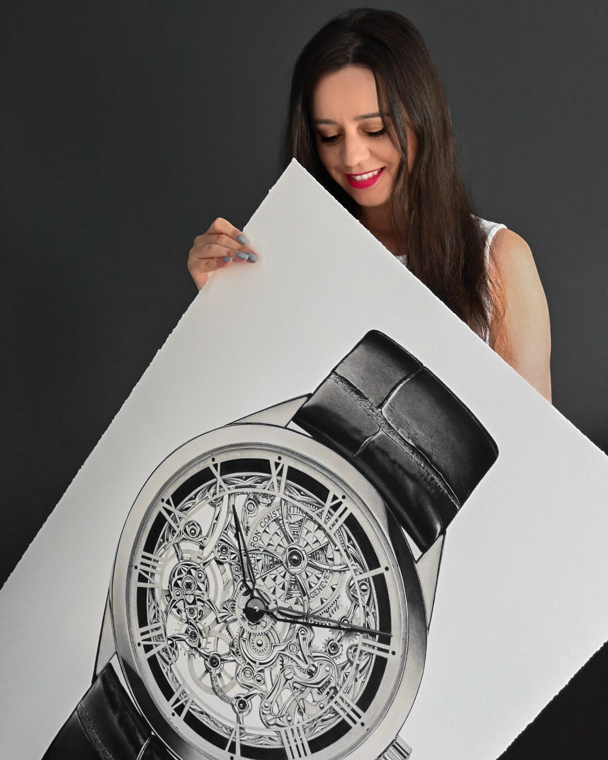 Sinziana Iordache holding her completed 22×30 inch graphite drawing inspired by the Vacheron Constantin Métiers d'Art Mécaniques Ajourées.