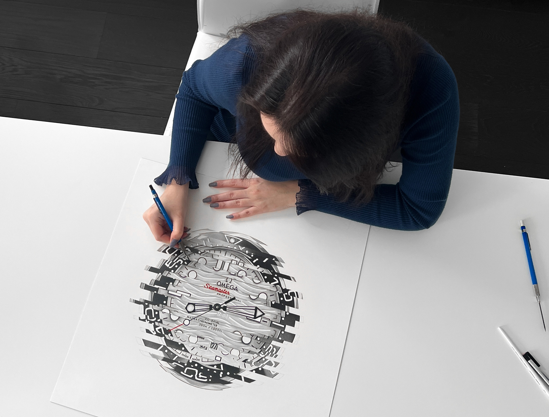 Sinziana Iordache working on a hyperrealistic watch drawing using graphite and coloured pencil techniques